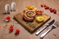 Grilled sausages with french fries with ketchup and mustard on a wooden stand Royalty Free Stock Photo