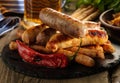 Grilled sausages with a glass of beer on a wooden table. Rustic Royalty Free Stock Photo