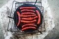 Grilled sausages grill flames smoke top view BBQ background flat Royalty Free Stock Photo