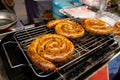 Grilled sausages on grill with smoke and flame on background Royalty Free Stock Photo