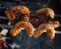 Grilled sausages on grill with smoke Royalty Free Stock Photo