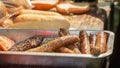 Grilled sausages for hot dogs on the background of buns in a fast food restaurant Royalty Free Stock Photo