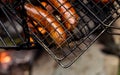 Juicy grilled sausages on the grill.