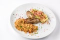 Grilled sausages, potatoes and braised cabbage on white plate close-up view from above. Royalty Free Stock Photo