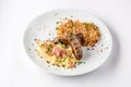 Grilled sausages, potatoes and braised cabbage on white plate close-up view from above. Royalty Free Stock Photo