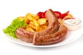 Grilled sausages with potatoes fries solated on white background