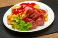 Grilled sausages with potatoes fries and sweet bulgarian peppers and red sauce ketchup Royalty Free Stock Photo