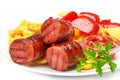 Grilled sausages with potatoes fries and sweet bulgarian peppers and red sauce ketchup Royalty Free Stock Photo