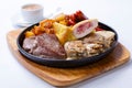 Grilled sausages with potatoes, mushrooms and roasted chicken on a grill pan Royalty Free Stock Photo