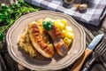 Grilled sausages, potatoes and sauerkraut Royalty Free Stock Photo