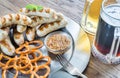 Grilled sausages with pretzels and mugs of beer Royalty Free Stock Photo