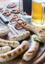 Grilled sausages with pretzels and mugs of beer Royalty Free Stock Photo