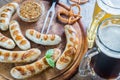 Grilled sausages with pretzels and mugs of beer Royalty Free Stock Photo