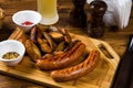 Grilled sausages with roast potato with spices