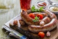 Grilled sausages served on wood board Royalty Free Stock Photo