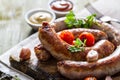 Grilled sausages served on wood board Royalty Free Stock Photo
