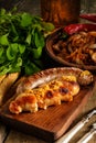 Grilled sausages and stewed cabbage with a mug of beer on a wood Royalty Free Stock Photo