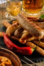 Grilled sausages and stewed cabbage with a mug of beer on a wood Royalty Free Stock Photo