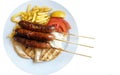 Grilled sausages on the stick with french fries