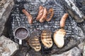 Grilled sausages, toast and and cup of coffee on campfire Royalty Free Stock Photo