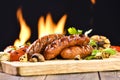 Grilled sausages and various vegetables on chopping wood Royalty Free Stock Photo