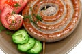 Grilled sausages with vegetables and dill close-up