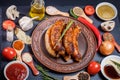 Grilled sausages, vegetables, hot peppers and various spices and ingredients on a black background Royalty Free Stock Photo