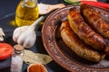 Grilled sausages, vegetables, hot peppers and various spices and ingredients on a black background Royalty Free Stock Photo