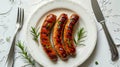 Grilled sausages on a white plate Royalty Free Stock Photo