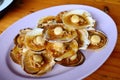 Grilled scallops topped with butter, garlic and onion