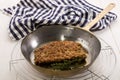 Grilled scottish kipper coated with oatmeal and thyme in a pan