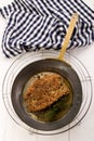 Grilled scottish kipper coated with oatmeal and thyme in a pan