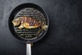 Grilled sea bream or dorado raw fish on grill hot pan over textured black background,  top view  with space for text Royalty Free Stock Photo