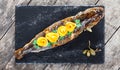 Grilled sea fish with lemon on stone slate background close up. Healthy food. Royalty Free Stock Photo