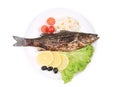 Grilled seabass on plate with vegetables.