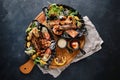 Grilled seafood platter. Assorted delicious grilled seafood with vegetables. Grilled mixed bastards with pepper sauce Royalty Free Stock Photo