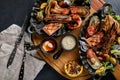 grilled seafood platter. Assorted delicious grilled seafood with vegetables. Grilled mixed bastards with pepper sauce Royalty Free Stock Photo