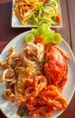 Grilled seafood platter with crab, fish, prawn and squid with lemon