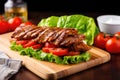 grilled seitan steak on bun, lettuce and tomatoes Royalty Free Stock Photo