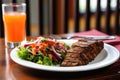 grilled seitan steak, colorful salad and glass of water Royalty Free Stock Photo