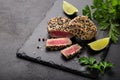 Grilled sesame tuna steak on black background