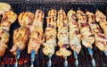 Grilled shish kebab on metal skewer. Chef hands cooking roasted meat barbecue with lots of smoke. Royalty Free Stock Photo