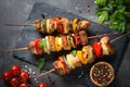 Grilled shish kebab with vegetables on black. Royalty Free Stock Photo