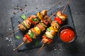 Grilled shish kebab with vegetables on black. Royalty Free Stock Photo