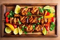 Grilled shish kebabs on skewers with vegetables on wooden table