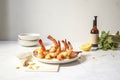 Grilled shrimp skewers. Seafood, shelfish. Shrimps Prawns skewers with herbs, garlic and lemon on black stone background