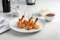 Grilled shrimp skewers. Seafood, shelfish. Shrimps Prawns skewers with herbs, garlic and lemon on black stone background