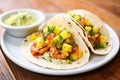 grilled shrimp tacos with mango salsa in soft tortillas