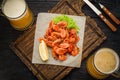 Grilled shrimps on a board and beer mug. Royalty Free Stock Photo