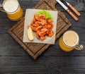 Grilled shrimps on a board and beer mug Royalty Free Stock Photo